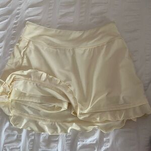 Cream colored skort with zippered pocket in back